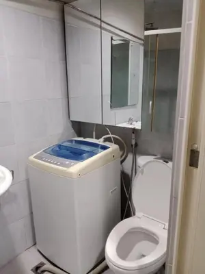 a small bathroom with a toilet and a mirror at Sea Residence Tower EF by Theresa P in Manila