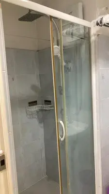 a shower with a glass door in a bathroom at Sea Residence Tower EF by Theresa P in Manila