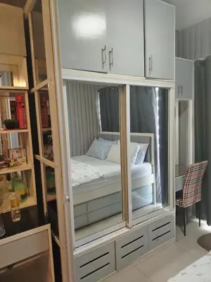 a cabinet with a bed inside of it at Shell Residence by Jas O in Manila