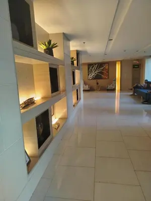 a large living room with a fireplace in a building at Shell Residence by Jas O in Manila
