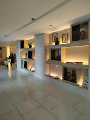 a lobby of a building with shelves with vases at Shell Residence by Jas O in Manila