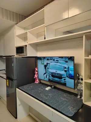 a tv in a kitchen with a car on the screen at Shell Residence by Jas O in Manila