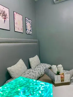 a bedroom with a bed with a blue bedspread at Balay Hayahay Staycation in Manila