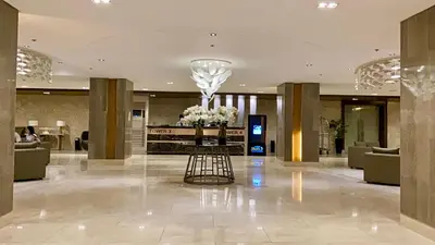 a lobby of a hotel with a vase of flowers at Balay Hayahay Staycation in Manila