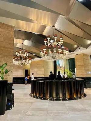 a lobby with people sitting at a bar in a building at Affordable Suite at Gramercy Makati with Balcony & Parking in Manila