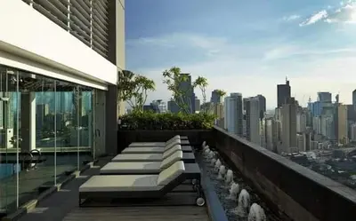 a balcony of a building with a view of a city at Affordable Suite at Gramercy Makati with Balcony & Parking in Manila