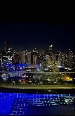 a view of a city at night with blue lights at Affordable Suite at Gramercy Makati with Balcony & Parking in Manila