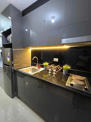 a kitchen with a sink and a counter with plants at Sakura Suites At Mall of Asia Near Airport in Manila