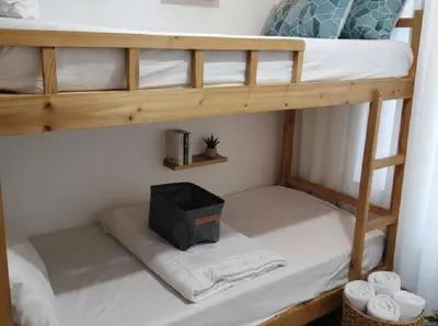 a bunk bed with a tv on the bottom bunk at Very Central Mall of Asia Manila Apartment in Manila