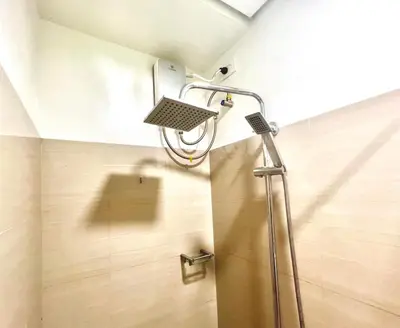 a shower with a shower head in a bathroom at MOA - Walking Distance to Mall Cheap Accommodation in Manila