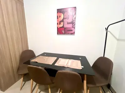 a black table with chairs in a room at MOA - Walking Distance to Mall Cheap Accommodation in Manila