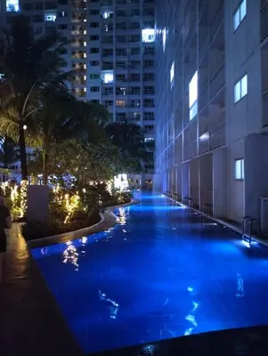 a pool in the middle of a building at night at MOA - Pasay Cheap Accommodation in Manila