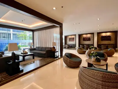 a large living room with couches and chairs at MOA - Aseana Value for Money Super Cozy Condo in Manila