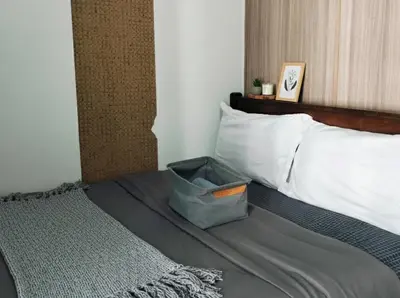a bed with a basket sitting on top of it at Mall Of Asia - Aseana Super Value for Money in Manila