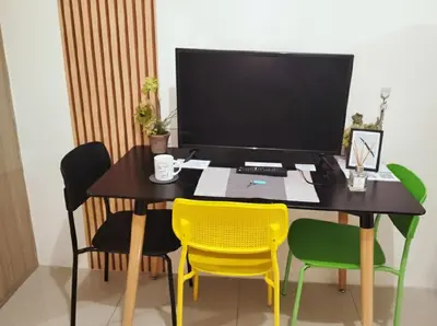 a desk with four chairs and a computer monitor at Mall of Asia - Aseana Super Cheap Accommodation in Manila