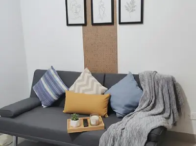 a couch with pillows and a blanket on it at Mall of Asia - Aseana Super Cheap Accommodation in Manila