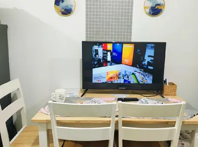 a table with two chairs and a television on it at Mall of Asia - Aseana Super Cheap Accommodation in Manila