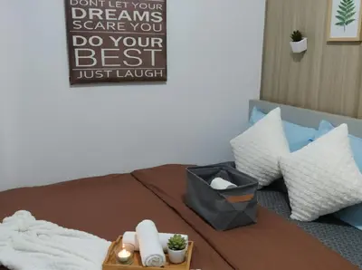 a bed with pillows and a sign that says dont let your dreams scare you at Mall of Asia - Aseana Nice and Cheap Apartment in Manila