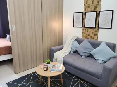 a living room with a couch and a table at Mall of Asia - Aseana Nice and Cheap Apartment in Manila