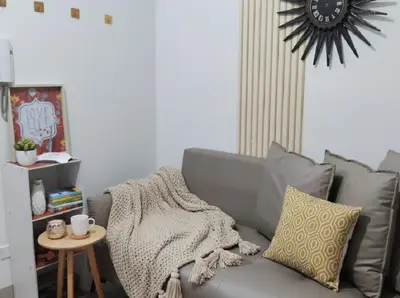 a living room with a gray couch and a table at Mall of Asia - Aseana Nice and Cheap Apartment in Manila