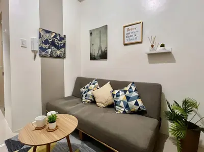 a living room with a couch and a table at Value for Money Mall of Asia - Aseana City Center in Manila