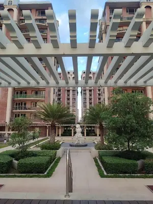 a courtyard with a fountain in front of a building at BP952 With Balcony and River View in Manila