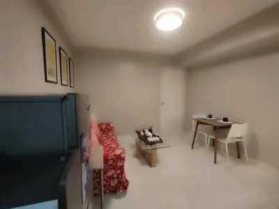 a room with a bed and a table in it at BP952 With Balcony and River View in Manila