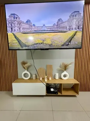 a flat screen tv hanging on a wall at Stylish Comfy and Cozy in Manila