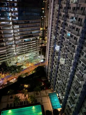 a view of a city at night with tall buildings at Stylish Comfy and Cozy in Manila