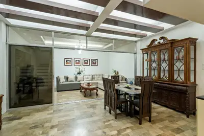 a living room with a table and a couch at Modern 4BR House with Billiards,KTV,WIFI,Netflix-10mins from Robinson Mall in Manila