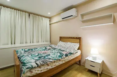 a small bedroom with a bed and a window at Modern 4BR House with Billiards,KTV,WIFI,Netflix-10mins from Robinson Mall in Manila