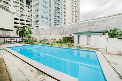 a swimming pool in the middle of a building at Modern 4BR House with Billiards,KTV,WIFI,Netflix-10mins from Robinson Mall in Manila