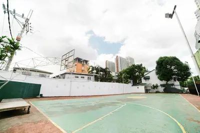 an empty basketball court with a white fence at Modern 4BR House with Billiards,KTV,WIFI,Netflix-10mins from Robinson Mall in Manila