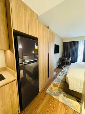 a hotel room with a bed and a large sliding door at Novotel Suites Residences Mandaluyong-Makati by Marj in Manila