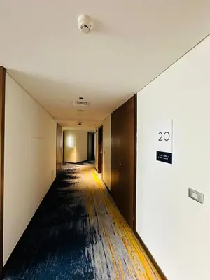 an empty hallway with a sign on the wall at Novotel Suites Residences Mandaluyong-Makati by Marj in Manila