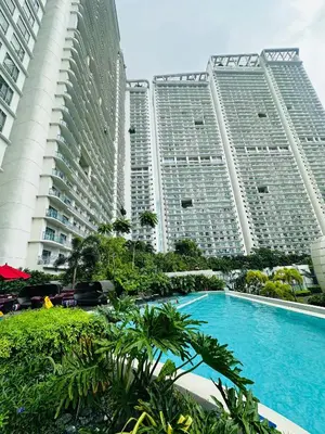 two tall buildings with a swimming pool in front of them at Novotel Suites Residences Mandaluyong-Makati by Marj in Manila