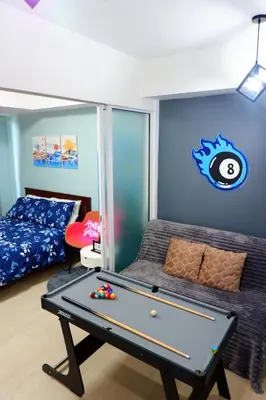 a room with a pool table and a bed at Azure Staycation By Star in Manila