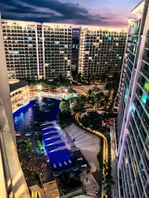 a view of a city at night with tall buildings at Azure Staycation By Star in Manila