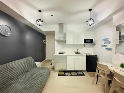 a kitchen with a bed and a table in a room at Azure Staycation By Star in Manila