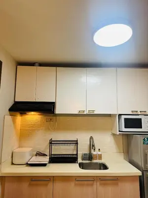 a kitchen with white cabinets and a sink at 2BR condo unit near BGC in Manila
