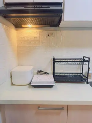 a kitchen counter with a counter top with a appliance at 2BR condo unit near BGC in Manila