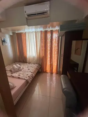 a small bed in a small room with curtains at 1441-Pool view 1BR 1 sofa Bed 1 Extra mattress in Manila