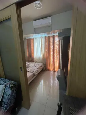 a small room with a bed and a window at 1441-Pool view 1BR 1 sofa Bed 1 Extra mattress in Manila