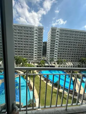 a view of the pool from the balcony of a hotel at Shell Residences pool view in Manila