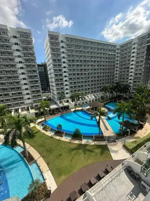 an aerial view of two large pools in a resort at Shell Residences pool view in Manila