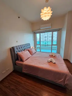 a bedroom with a large bed with a large window at Beacon Makati Skyline View in Manila