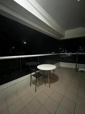 a table and chairs in a room with a view at Beacon Makati Skyline View in Manila