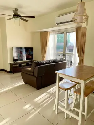 a living room with a couch and a table at 5 Star Luxury Condo - Metro Manila in Manila
