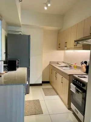 a kitchen with a refrigerator and a stove top oven at 5 Star Luxury Condo - Metro Manila in Manila