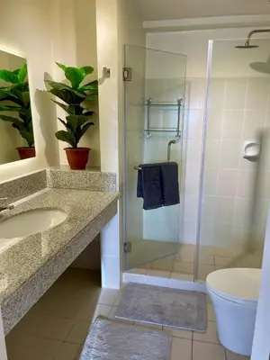 a bathroom with a shower and a sink and a toilet at 5 Star Luxury Condo - Metro Manila in Manila